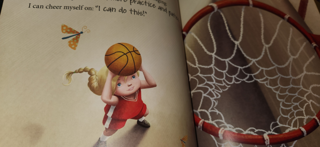 illustration of a girl playing basketball, fetting ready to make a shot. The text has the girl telling herself that she can do it. 